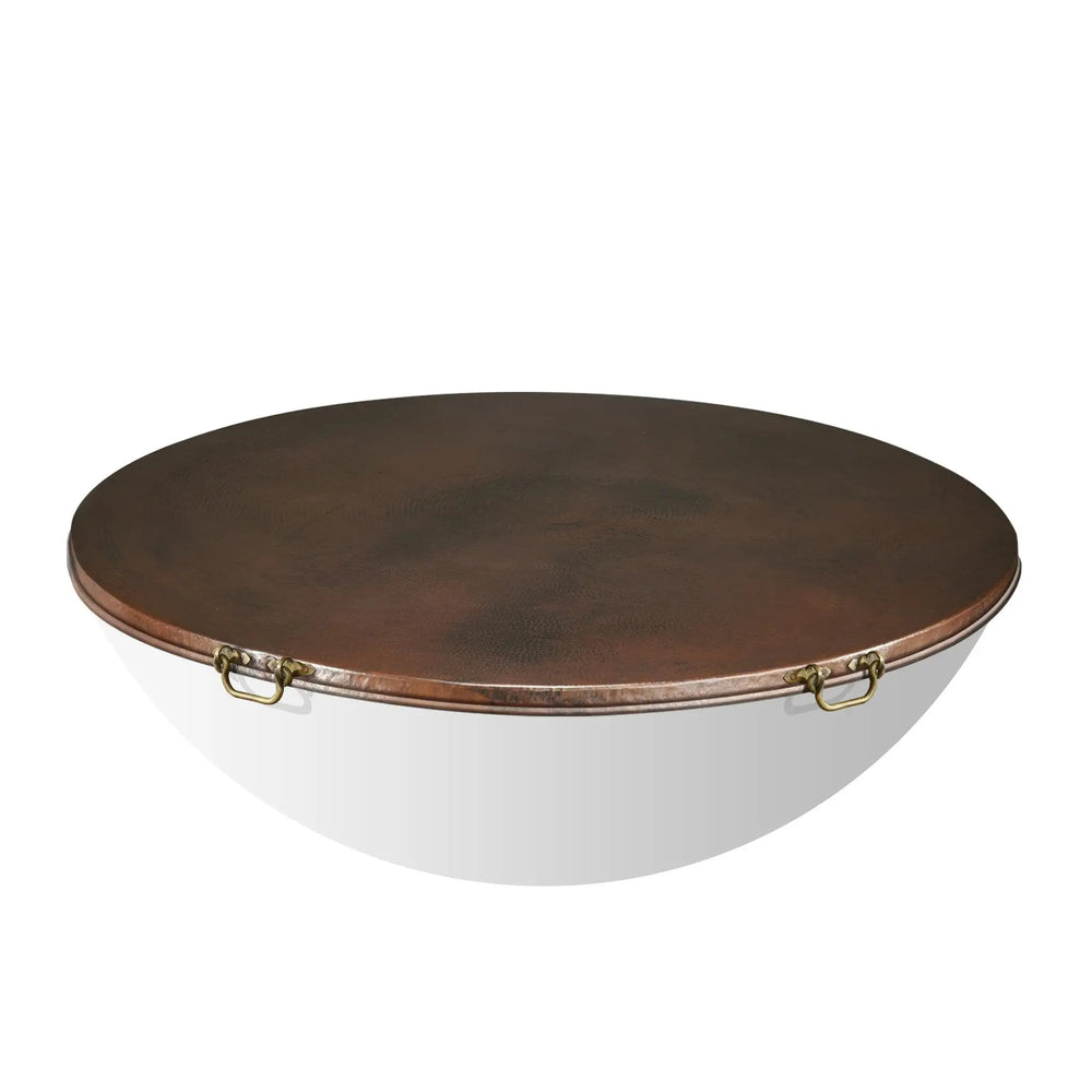 Moreno 54-inch round copper fire pit lid by Starfire Designs, displayed on a white background. Featuring a hammered copper finish and two brass handles, this lid provides protection and adds a touch of luxury to outdoor fire pits and fire tables. Perfect for covering large fire bowls in high-end backyard and patio settings