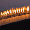 An intimate close-up of extra small volcanic lava rocks, highlighting their rough, porous texture. These rocks, designed for outdoor fire features, create a rustic and authentic look, blending durability and style. Their dark, natural color complements the fiery ambiance in any outdoor or indoor fire feature. 