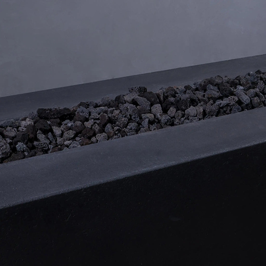 A close-up view of Outdoor Volcanic Lava Rock (small size) in use inside a fire pit, showcasing the durable, heat-retaining properties of the stones. Their natural, rugged appearance adds texture and a modern look to any fire feature, while effectively distributing heat