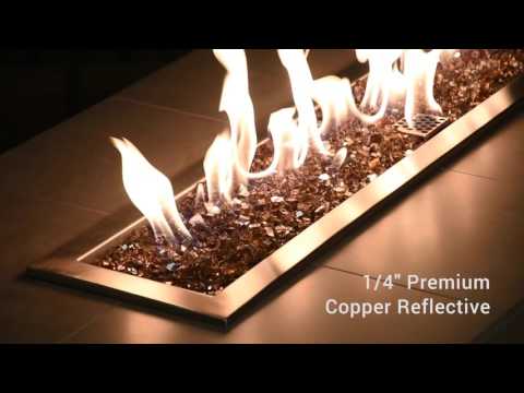 A modern linear fire pit filled with American Fire Products 1/4" Copper Reflective Fire Glass, glowing with dynamic flames that dance across the rich amber-toned glass—blending radiant warmth and contemporary elegance for a luxurious outdoor ambiance.