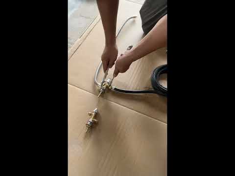 YouTube thumbnail showing the step-by-step installation of the Starfire Designs Béton Fire Pit Replacement Valve for Natural Gas or Propane, demonstrating how to properly connect brass fittings, fuel lines, and secure components for safe fire pit operation.