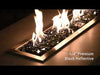 Dancing flames rise above a sleek bed of American Fire Products 1/4" black reflective fire glass, showcasing the striking contrast between glowing firelight and the polished, mirror-like surface of deep black glass—perfect for upscale, contemporary outdoor fire features.