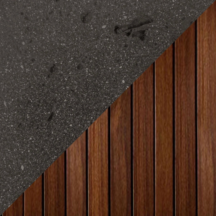 Close-up swatch of Prism Hardscapes Manchester Fire Table in Ebony color, featuring a deep black concrete finish and vertical wood panel detailing. The dramatic contrast of dark concrete and wood paneling adds a bold, modern aesthetic to outdoor fire pits, making it suitable for contemporary backyards and luxury patio designs.