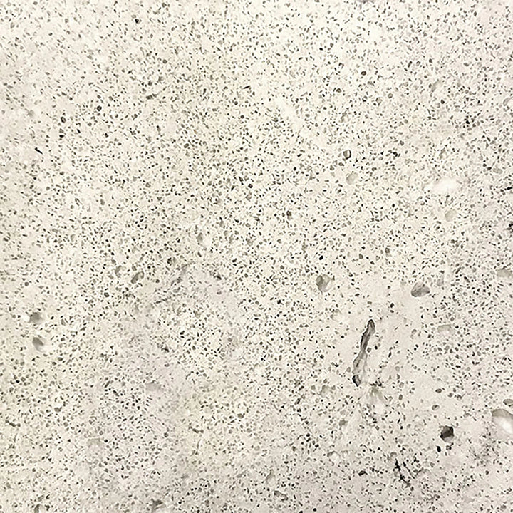 The Prism Hardscapes Moderno 3 gas fire pit swatch in natural features a light, neutral gray color with a subtly textured concrete surface. This versatile shade fits seamlessly into any outdoor decor, making it ideal for modern fire pits or fire bowls. The natural color complements both greenery and hardscapes in outdoor living areas, offering both beauty and resilience. Perfect for fire pits in modern outdoor spaces.