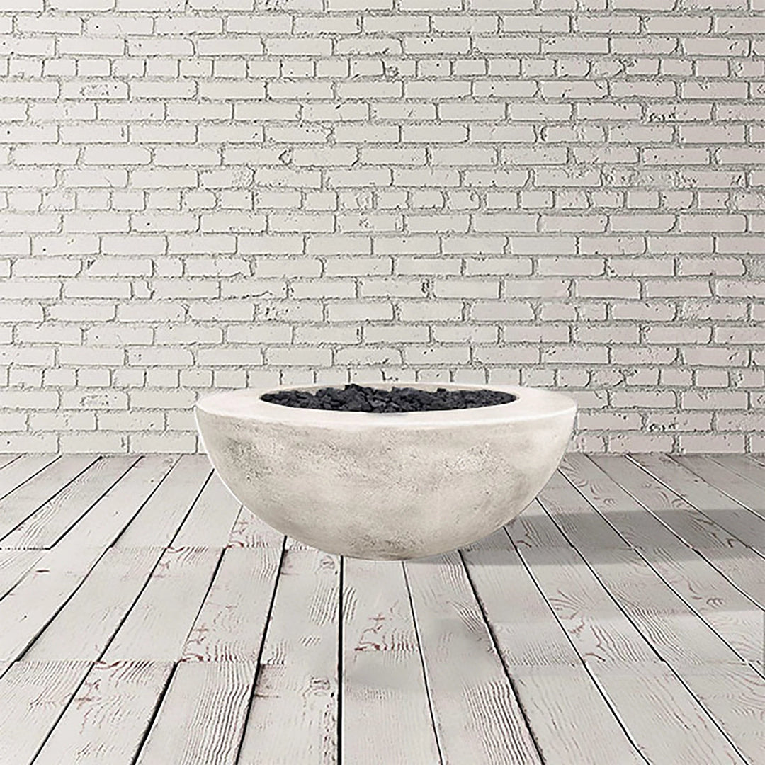 Prism Hardscapes Moderno 5 Gas Fire Pit in Natural Gray, presenting a light gray round concrete fire bowl. This outdoor fire pit delivers style and functionality, designed for both natural gas and propane fuel types. It's perfect for enhancing outdoor spaces with a modern touch while providing warmth and atmosphere. A great addition to patios and gardens, this fire pit is built for durability and outdoor enjoyment.