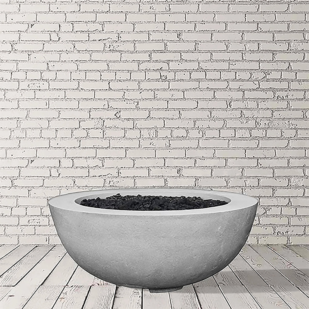 Prism Hardscapes Moderno 8 Gas Fire Bowl in Natural Gray finish, showcasing a textured concrete surface with a smooth, minimalist design. This round gas fire bowl fits seamlessly into any outdoor patio or backyard area, perfect for both propane and natural gas configurations. A modern outdoor fire pit ideal for creating a warm and inviting atmosphere.