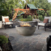 Prism Hardscapes Moderno 1 Gas Fire Bowl situated in a beautifully landscaped garden patio with surrounding seating. This modern fire pit provides warmth and elegance to outdoor gatherings, making it a perfect addition to any backyard or commercial outdoor space. Designed for both residential and luxury commercial environments.