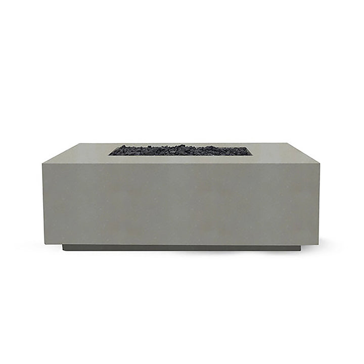 Showcased here is the Prism Hardscapes Portos 58" Propane Fire Table in natural finish, blending seamlessly into a lush outdoor scene. The natural beige hue adds warmth and elegance to any patio or backyard setup, making it ideal for a fire pit outdoor gas installation. This durable fire table combines practicality with beauty, featuring a large burner area filled with black lava rock. Perfect for backyard fire pit lovers who appreciate natural tones.