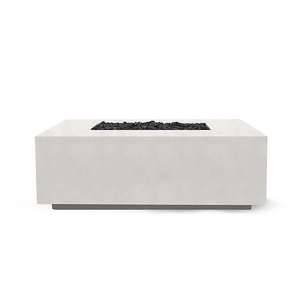 The Prism Hardscapes Portos 58" Propane Fire Table in ultra-white is showcased in a modern outdoor setting, creating a striking contrast with nature. This bright and contemporary fire table offers a clean, minimalist design with a smooth concrete surface. It provides a powerful propane flame that makes it ideal for both commercial fire pits and backyard fire pit areas. This fire table is perfect for those looking for a sleek and modern fire pit for their patio or outdoor space.