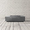 Prism Hardscapes Tavola 1 Gas Fire Pit in a natural grey finish, presented in a sleek studio setting. The rectangular fire pit offers a blend of simplicity and durability, crafted from concrete with a natural, neutral tone. Ideal for any backyard or patio, the gas-powered fire pit delivers warmth and ambiance for outdoor gatherings. Its natural grey color makes it versatile for various decor styles. 