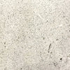 Close-up swatch of the Prism Hardscapes Tavola 1 Gas Fire Pit in a natural gray color, featuring a lightly speckled, weathered texture. This versatile and timeless shade is perfect for outdoor fire pits, enhancing any backyard or patio space with a modern yet rustic look. Ideal for fire pit tables and concrete fire pits