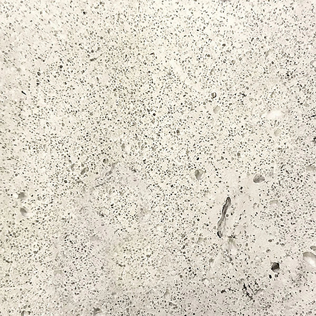 Close-up of the Prism Hardscapes Tavola 2 Gas Fire Pit in Natural, featuring a light, textured concrete surface. This natural finish is perfect for blending seamlessly into a range of outdoor fire pit designs. The rugged yet smooth texture adds a sophisticated touch to any backyard or patio setting.