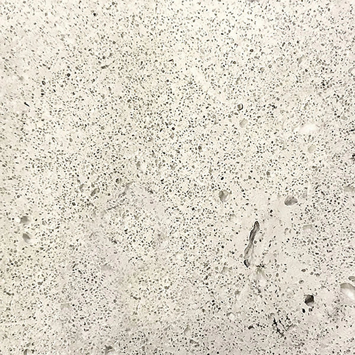 Close-up of the Prism Hardscapes Tavola 2 Gas Fire Pit in Natural, featuring a light, textured concrete surface. This natural finish is perfect for blending seamlessly into a range of outdoor fire pit designs. The rugged yet smooth texture adds a sophisticated touch to any backyard or patio setting.