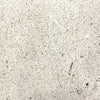 Closeup of the Prism Hardscapes Tavola 4 Gas Fire Pit swatch in natural color. This natural gray concrete finish emphasizes the simplicity and elegance of the material, ideal for minimalist and contemporary outdoor spaces. The surface’s textured details add to the fire pit’s robust durability, making it perfect for year-round use in gardens or patio areas