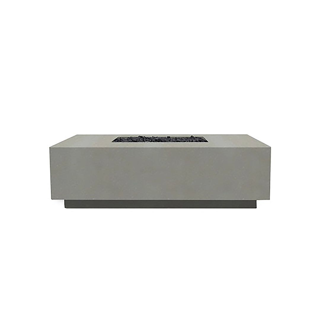 Prism Hardscapes Tavola 7 Gas Fire Pit in natural finish, featuring a natural concrete look that blends seamlessly with outdoor environments. The low-profile design and rectangular shape make this fire pit a centerpiece for patios or backyards. Designed for gas-fueled flames, it offers warmth and ambiance with a sleek, contemporary aesthetic. 