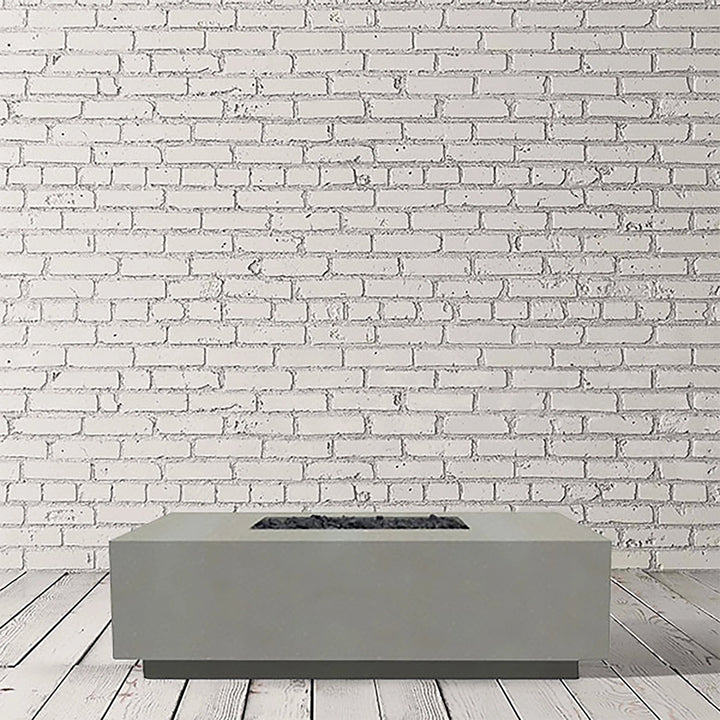 Prism Hardscapes Tavola 7 Gas Fire Pit in natural finish, displayed in a studio setting to emphasize its raw concrete texture. This modern, rectangular gas fire pit features a low-profile design that fits seamlessly into various outdoor spaces. The natural finish offers a versatile and timeless look, perfect for patios and backyards. 