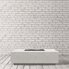 Prism Hardscapes Tavola 7 Gas Fire Pit in ultra white finish, featured in a bright, minimalist studio backdrop. The fire pit's clean, low-profile design adds a modern touch to any outdoor living space. Made from durable concrete, this gas-powered fire pit offers a crisp, sophisticated look for contemporary patios. 