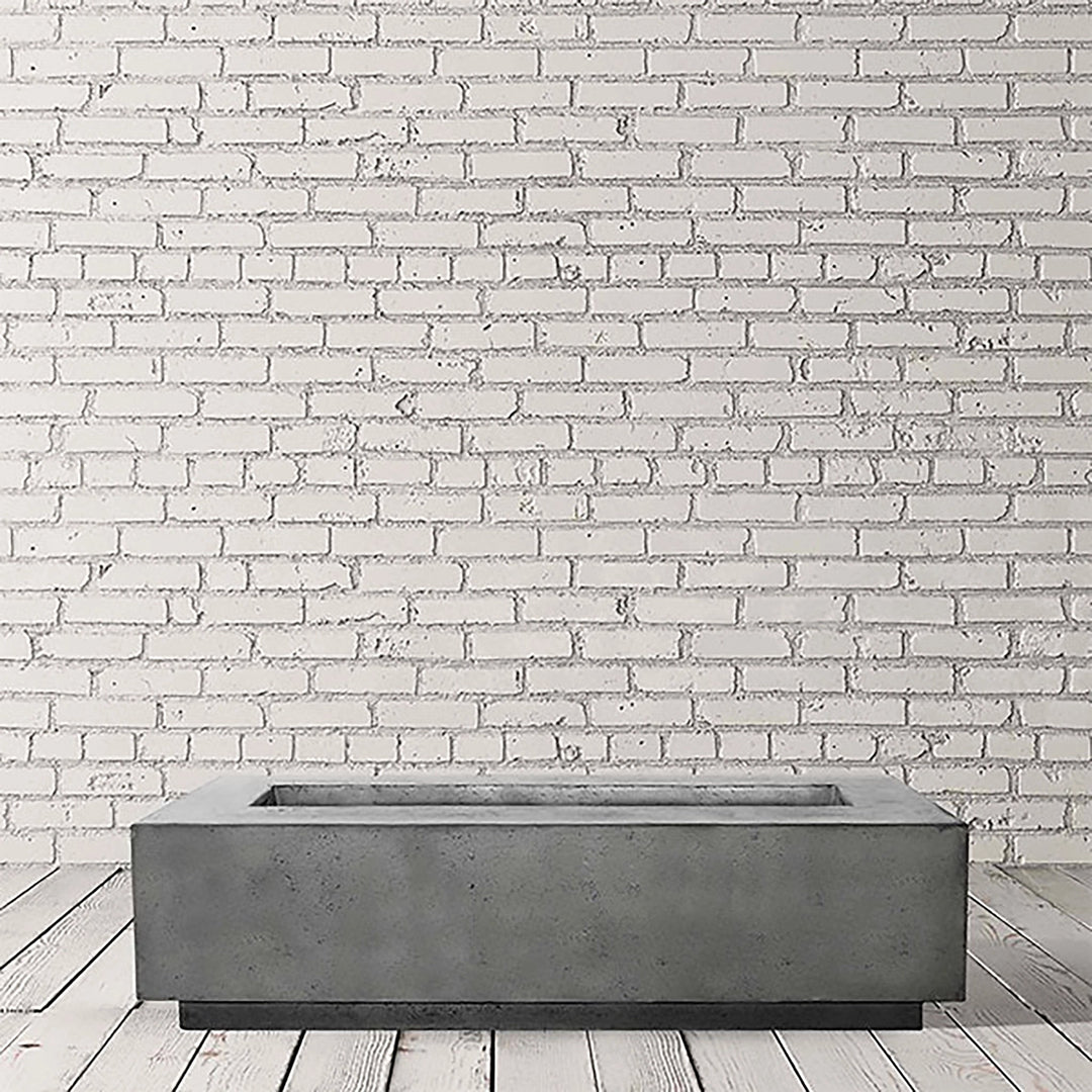 Studio shot of the Prism Hardscapes Tavola 72 Gas Fire Pit in Pewter finish. With its sleek, industrial-inspired design, this fire pit is a stylish addition to modern outdoor spaces. The durable concrete construction and large size make it ideal for outdoor patios, backyard fire features, and luxury gas fire pit installations.