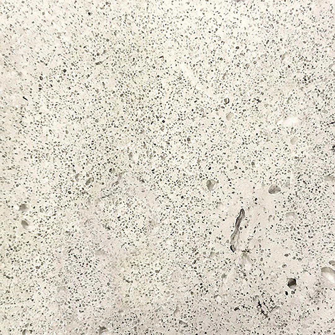 Swatch view of the Prism Hardscapes Tavola 8 Gas Fire Pit in Natural finish, featuring the light, raw concrete texture. This natural light gray tone blends seamlessly into any outdoor space, offering a minimalist and neutral aesthetic. Perfect for those seeking a clean and simple design. Natural concrete fire pit, neutral outdoor gas fire pit, raw concrete finish, minimalist fire pit, light-colored fire pit.