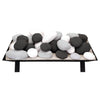 Large layered stack of black, white, and light gray Rasmussen Vented FireStones on a vented tray. Suitable for gas fireplaces, this mix of colors and textures brings a modern and refined look to outdoor heating spaces.