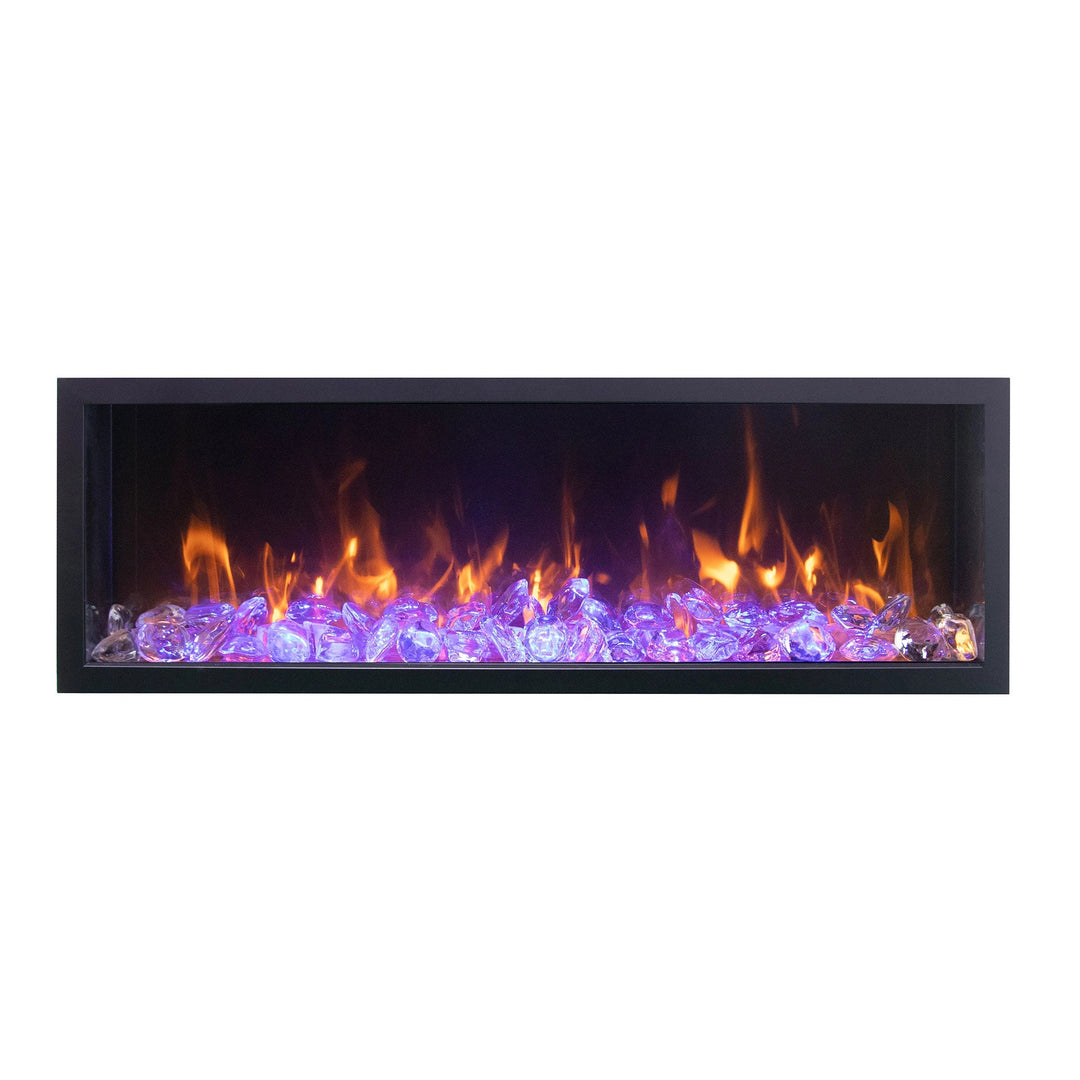 A front view of the Remii Tall Indoor/Outdoor Built-In Electric Fireplace with vibrant purple flames and reflective clear crystals. Perfect for enhancing ambiance in living rooms or patios, this electric fireplace offers sleek aesthetics and customizable heat control.