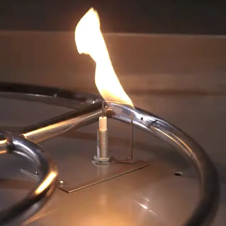 A closeup photo of the spark ignition system in a fire pit being lit easily