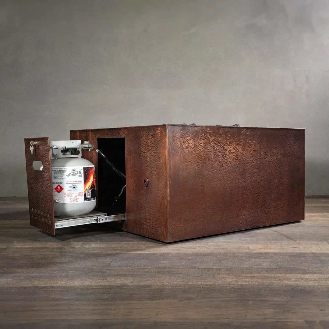 "45-inch square copper fire pit by Starfire Designs with a hidden propane tank storage, featuring a pull-out access drawer, hammered copper finish, and robust construction for modern outdoor patios