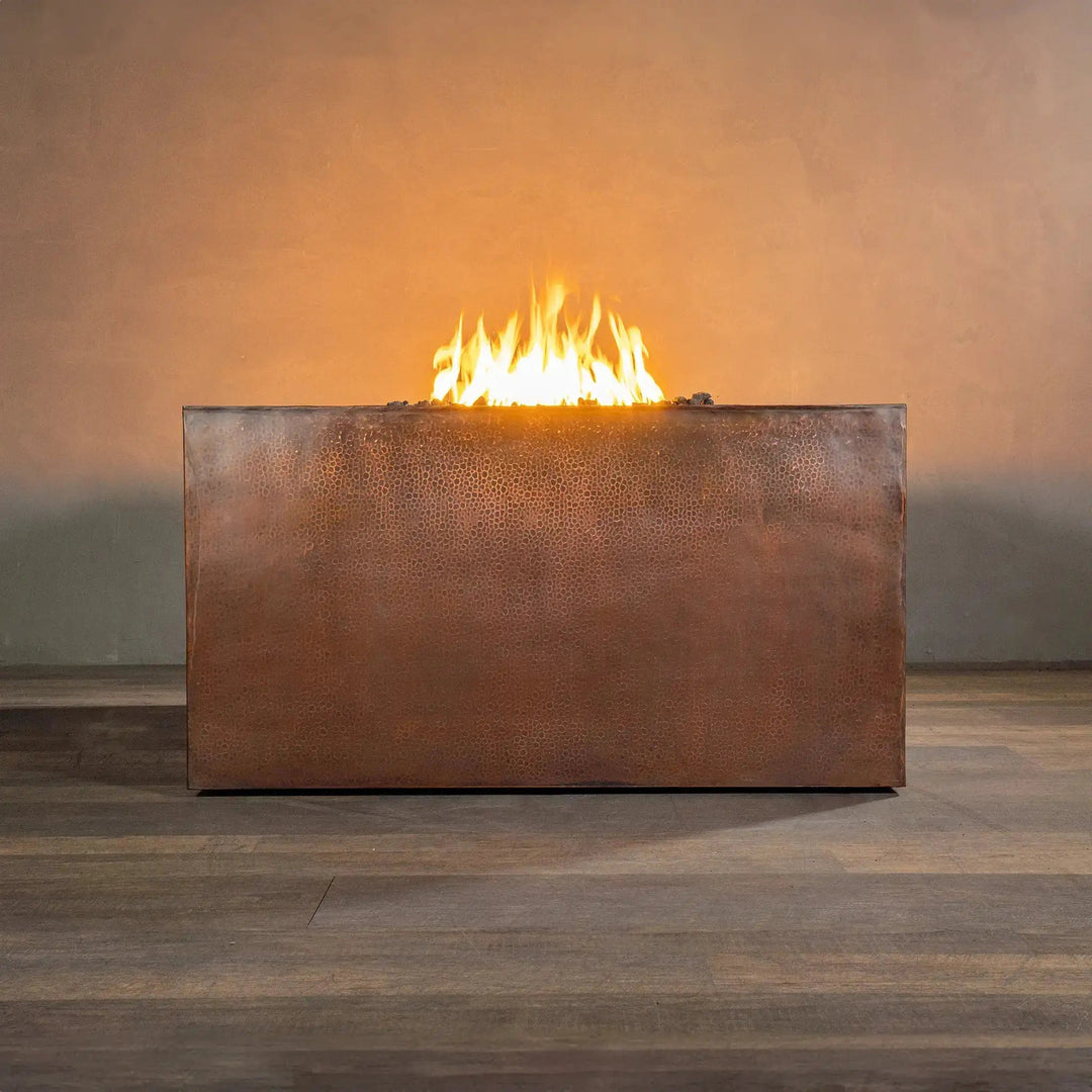 Side view of a 45-inch square copper outdoor fire pit from the Gravity Moreno collection by Starfire Designs, showcasing its sleek, hammered copper finish and modern design, ideal for luxury outdoor settings and patios