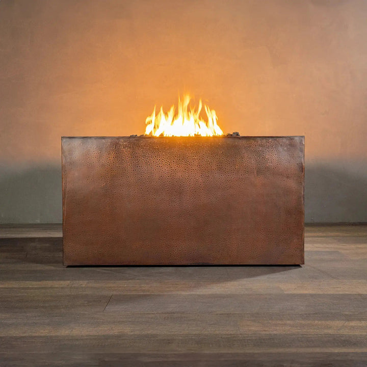 Side view of a 45-inch square copper outdoor fire pit from the Gravity Moreno collection by Starfire Designs, showcasing its sleek, hammered copper finish and modern design, ideal for luxury outdoor settings and patios