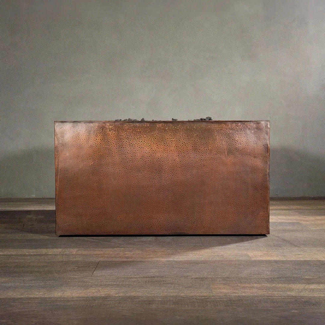 Side view of a 45-inch square copper fire pit from the Gravity Moreno collection by Starfire Designs, showcasing the textured hammered copper finish and clean, modern lines, ideal for upscale outdoor and patio areas