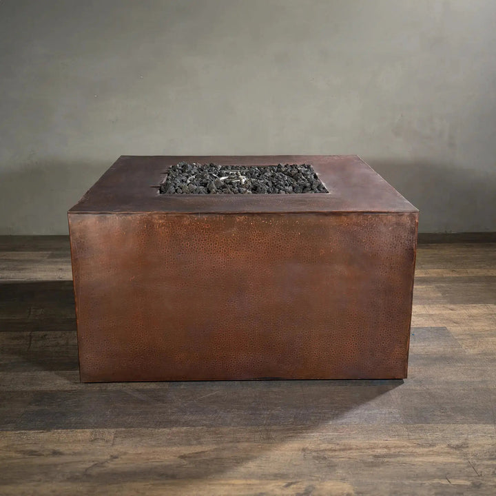 Unlit view of a 45-inch square copper fire pit from the Gravity Moreno collection by Starfire Designs, highlighting its rustic hammered copper surface and modern design, perfect for luxurious outdoor and patio spaces