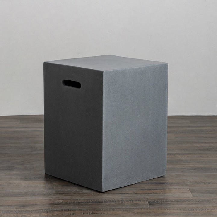 Angled side view of the Starfire Designs Beton 16-inch Natural Gray Square Propane Tank Cover, showcasing its minimalist design with built-in hand slots for easy portability. Made from high-quality materials, this cover combines functionality and style, ideal for complementing outdoor gas fire pits and backyard decor.