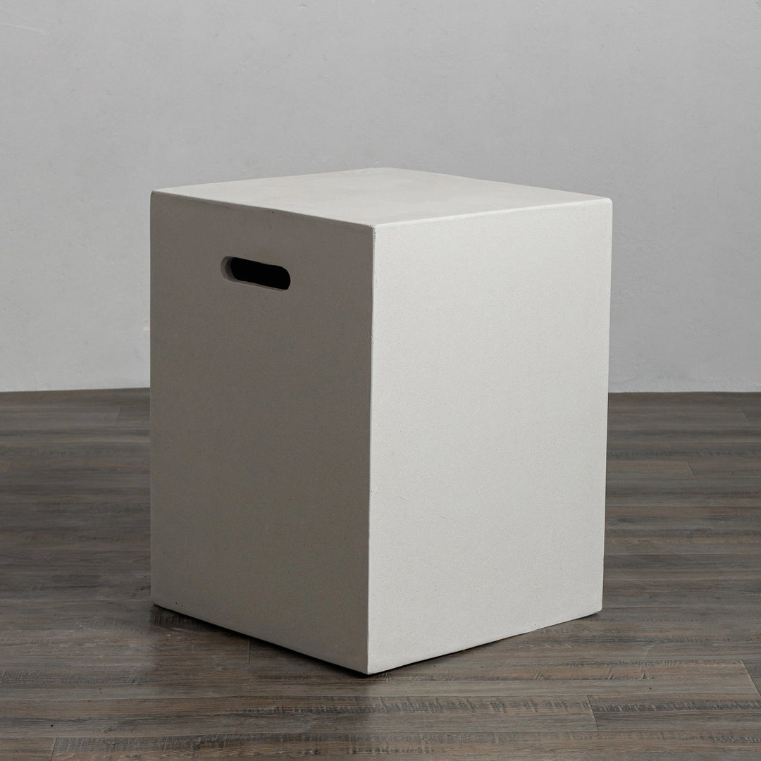 Angled view of the Starfire Designs Beton 16-inch white square propane tank cover with sleek modern design, concrete material, and built-in handles for easy transport. This cover blends effortlessly with outdoor furniture and fire pits.