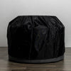 Starfire Designs Beton 42-inch Graphite Round Concrete Gas Fire Pit covered with a weather-resistant black protective cover, designed to shield the fire pit from the elements and prolong its lifespan while maintaining a stylish profile.