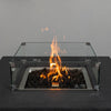 Close-up of the flames inside the Starfire Designs Beton 42" Graphite Fire Pit, with the glass wind guard enhancing safety and style. The perfect addition to outdoor spaces.