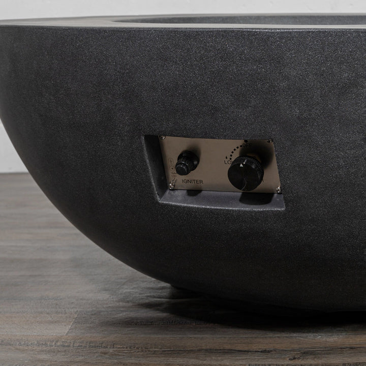 Close-up view of the push-button ignition system and adjustable flame controls of the Starfire Designs Beton 42 Inch Graphite Round Concrete Natural Gas Fire Pit, showcasing the sleek stainless-steel panel and intuitive operation for enhanced usability and modern outdoor fire pit design.