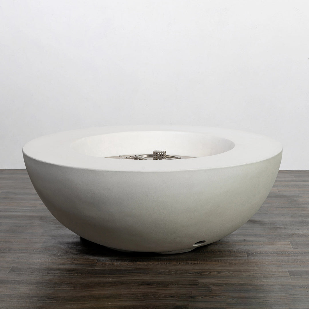 Side view of the Starfire Designs Beton 42 Inch White Round Concrete Natural Gas Fire Pit with Push Button Ignition, showcasing its smooth white concrete finish and sturdy round shape, perfect for modern outdoor spaces.