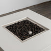 Close-up of the burner area in the Starfire Designs Beton 42" White Square Hidden Propane Tank Gas Fire Pit, filled with premium lava rocks for enhanced heat retention and natural aesthetics.