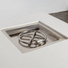 A close-up view of the stainless steel burner inside the Starfire Designs Beton 42" White Square Hidden Propane Tank Gas Fire Pit, highlighting the durable circular burner and clean recessed design for even flame distribution.