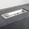 Top-down view of the stainless steel burner tray inside the Starfire Designs Beton 55" Graphite Rectangle Hidden Propane Tank Gas Fire Pit. The image captures the linear burner system, perforated flame guard, and sleek edge design. Keywords: outdoor fire pit, propane fire pit, stainless steel burner, modern backyard fire feature.