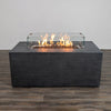 Front view of the Starfire Designs Beton 55" Graphite Rectangle Hidden Propane Tank Gas Fire Pit in use, displaying vibrant flames behind the tempered glass wind guard. This fire pit combines modern luxury with functional warmth, making it an eye-catching centerpiece for outdoor entertaining spaces.