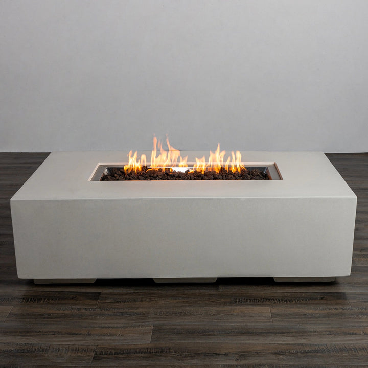 Front view of the Starfire Designs Beton 55" White Rectangle Gas Fire Pit with bright, flickering flames. The sleek, minimalist concrete design in white pairs beautifully with any modern patio or backyard decor. 