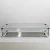 This image features the Starfire Designs Beton 55" White Rectangle Hidden Propane Tank Gas Fire Pit fitted with a tempered glass wind guard. The sleek glass panels are secured with stainless steel brackets, surrounding the burner for protection against wind while enhancing visibility of the flames. The white finish complements the minimalist design. 