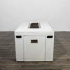 The Starfire Designs Beton 55" White Rectangle Hidden Propane Tank Gas Fire Pit is shown from the side with the tank compartment door closed. The hidden door blends into the rectangular body, featuring a brushed stainless steel handle for access. The fire pit’s smooth white concrete finish enhances its contemporary style.