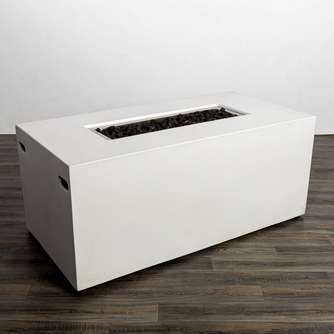 This image shows the Starfire Designs Beton 55" White Rectangle Hidden Propane Tank Gas Fire Pit with the burner unlit, displaying its elegant design and natural lava rock filler. The rectangular cutout for the burner sits flush with the white concrete surface, offering a seamless appearance.
