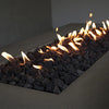 A close-up view of the Starfire Designs Concrete Rustic 60" x 32" Rectangle Gravity Gas Fire Pit in brown, focusing on the glowing flames dancing above black lava rocks. The natural texture of the concrete contrasts beautifully with the fire and rocks, creating a captivating scene. This fire pit is ideal for bringing warmth and a rustic touch to modern outdoor environments.