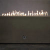 A side view of the Starfire Designs Concrete Rustic 60" x 32" Rectangle Gravity Gas Fire Pit in brown, showcasing a steady line of flames across the top. The smooth concrete finish and minimalist design provide a rustic yet contemporary look. Perfect for outdoor gatherings, this rectangular fire pit adds warmth and elegance to patios and backyards. The durable construction ensures it withstands the elements for years of enjoyment