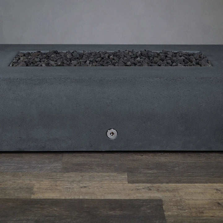 Close-up of the burner control on the Starfire Designs Concrete Rustic 60" x 32" Rectangle Gravity Gas Fire Pit in Graphite, showcasing the easy-to-use ignition system. Designed for convenience, this fire pit allows for quick flame adjustments to create the perfect outdoor ambiance