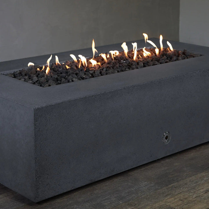 Corner view of the Starfire Designs Concrete Rustic 60" x 32" Rectangle Gravity Gas Fire Pit in Graphite. The durable concrete construction and graphite color give this fire pit a timeless, modern look, making it the perfect addition to outdoor living spaces