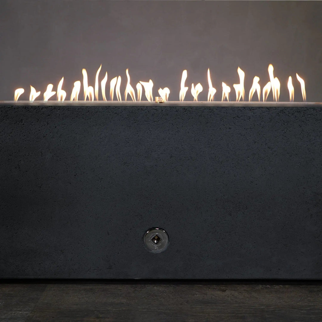 Close-up of the flames from the Starfire Designs Concrete Rustic 60" x 32" Rectangle Gravity Gas Fire Pit in Graphite, highlighting the even flame distribution and stainless steel burner system. This fire pit delivers a mesmerizing flame display, perfect for creating an inviting outdoor atmosphere